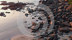 Rocky beach near Palolem beach at sunset. Goa State. India.