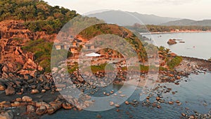 Rocky beach near Palolem beach at sunset. Goa State. India.