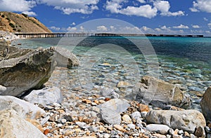 a rocky beach next to a body of water on south australian coastline