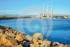 Rocky beach and an old power plants at whose three large smokestacks can be seen from anywhere in Morro Bay. Morro Bay State Park,