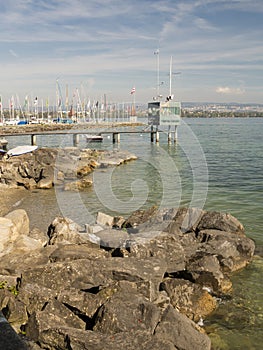 Rocky beach and pier at Veytaux on Geneva lake