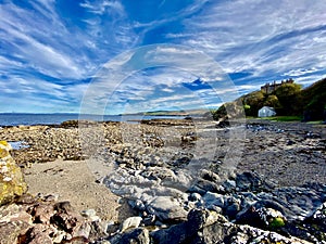 Rocky Beach and sea scene, Culzean Castle behind. Ayrshire Scotland.