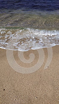 A Rocky beach with a seawave