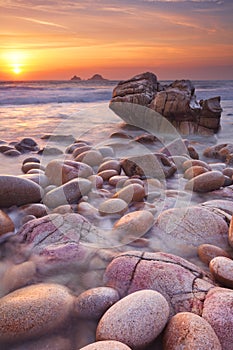 Rocky beach at sunset in Cornwall, England