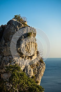 Rocky cliff above Aegean sea at sunset in Sithonia