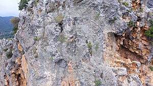 Rocky cliff above the forested valley and country road.