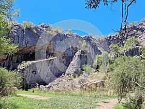 Rocky cliff face with fallen boulders at the base