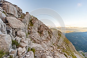 Rocky cliff with golden light on the Apuan Alps Alpi Apuane, Tuscany, Lucca photo