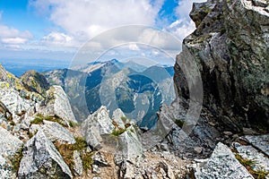 Rocky cliff overlooking a majestic mountain range. High Tatra Mountains, Slovakia.