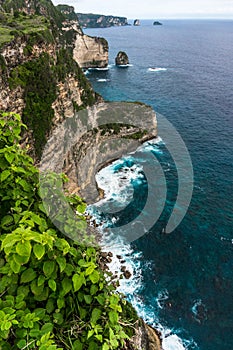 Rocky cliff and sea waves