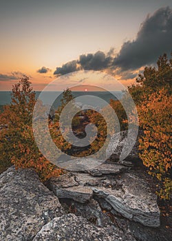A rocky cliff with trees and a sunset in the background, Cragsmoor, Shawangunk Mountains, New York