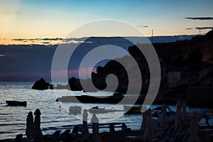 Rocky cliffs at Golden Bay Beach during blue hour