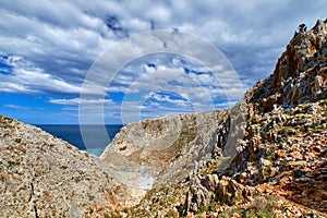 Rocky cliffs of typical Greek sea shores, blue sea, blue sky, beautiful sky. Stefanou beach, Seitan Limania, Chania