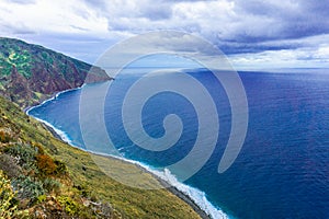 Rocky coast of Atlantic ocean at Madeira archipelago in Portugal at cloudy day