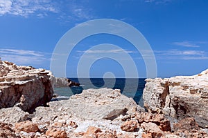 Rocky coast by the bay Cala Portinatx. Ibiza. Balearic Islands, Spain