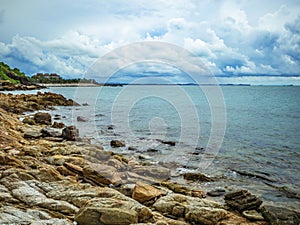 Rocky coast beach in idylic ocean and sky