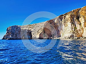 Rocky coast and blue sky.   Seascape with beautiful sea and rocks. Calm sea water. River between canyons. Aaeolian island day trip