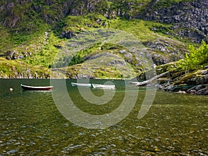 The rocky coast of the fjord of Norway. Fishing boats