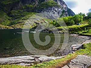 The rocky coast of the fjord of Norway. Fishing boats