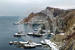 Rocky coast on a foggy day in winter, Nakhodka, Russia