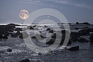 Rocky coast in a full moon night