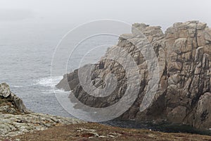 Rocky coast of the island Ouessant, in the fog