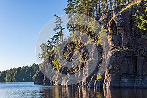 The rocky coast of the island of Valaam overgrown with pine trees