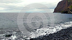 Rocky coast of the island. Volcanic rocks.