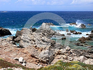 Rocky coast on mediterranean sea with wild waves