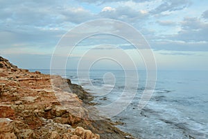 Rocky coast on sunset on a cloudy evening