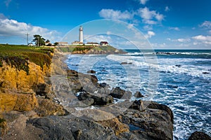 Rocky coast and view of Piegon Point Lighthouse in Pescadero, Ca