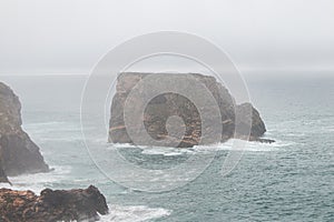 Rocky coastline of the Atlantic Ocean in the south-west of Portugal in the Algarve region. Exploring the beautiful rugged nature