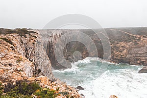 Rocky coastline of the Atlantic Ocean in the south-west of Portugal in the Algarve region. Exploring the beautiful rugged nature
