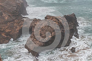 Rocky coastline of the Atlantic Ocean in the south-west of Portugal in the Algarve region. Exploring the beautiful rugged nature