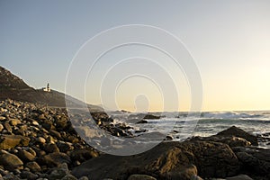 Rocky coastline and Cabo Silleiro lighthouse photo