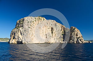 Rock and cliff in blue sea photo