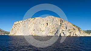 Rock and cliff in blue sea photo
