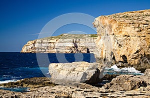 Rocky coastline cliffs near collapsed Azure window, Gozo island, Malta