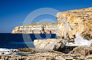 Rocky coastline cliffs near collapsed Azure window, Gozo island, Malta