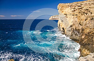 Rocky coastline cliffs near collapsed Azure window, Gozo island, Malta