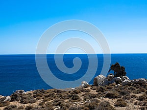 Rocky coastline, crystal clear water and blue sky. East side of Rhodes Island. Greece.