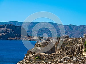 Rocky coastline, crystal clear water and blue sky. East side of Rhodes Island. Greece.