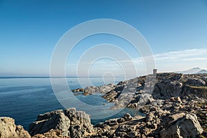 Rocky coastline and Genoese tower at Punta Spano in Corsica