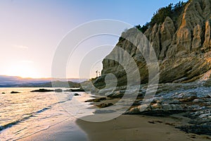 Rocky coastline at low tide at sunset, California