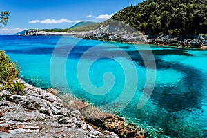 Rocky coastline near Dafnoudi beach in Kefalonia, Greece. Isolated bay with pure crystal clean turquoise sea water