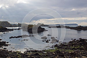 The rocky coastline overlooking Whitepark Bay to the north from Ballintoy harbor on the North Antrim coast in Northern Ireland photo