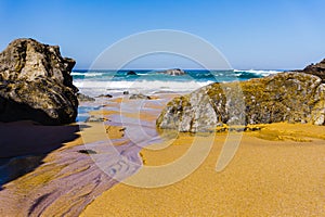 Rocky coastline of sandy Adraga beach, Portugal