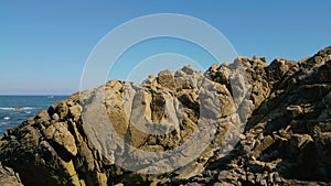 Rocky Coastline On A Sunny Day In Furna de Caion - aerial ascend