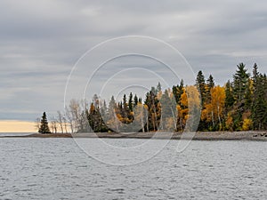 Rocky Coastline and Trees with Fall Foliage Along the Little Two Harbors on Lake Superior on a Stormy Day