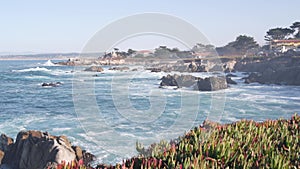 Rocky craggy ocean beach, sea waves crashing on shore, Monterey California coast